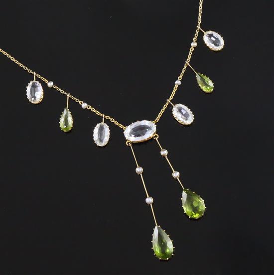 An Edwardian 9ct gold, peridot, aquamarine and split pearl drop pendant necklace, 44cm.